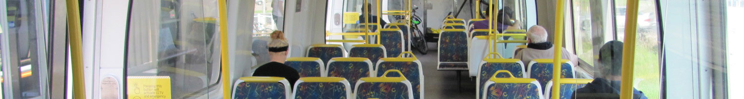 The familiy blue, yellow and white colour scheme of a Melbourne train interior.