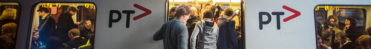 A city train packed full of commuters.